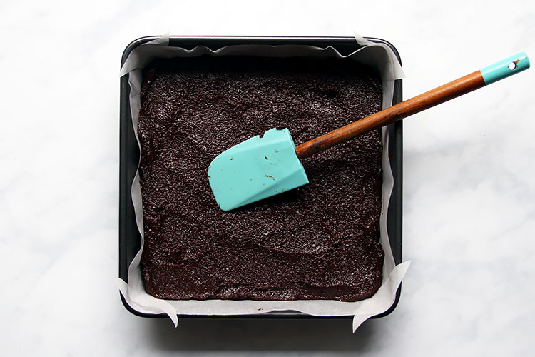 Spreading poppy seed batter in pan