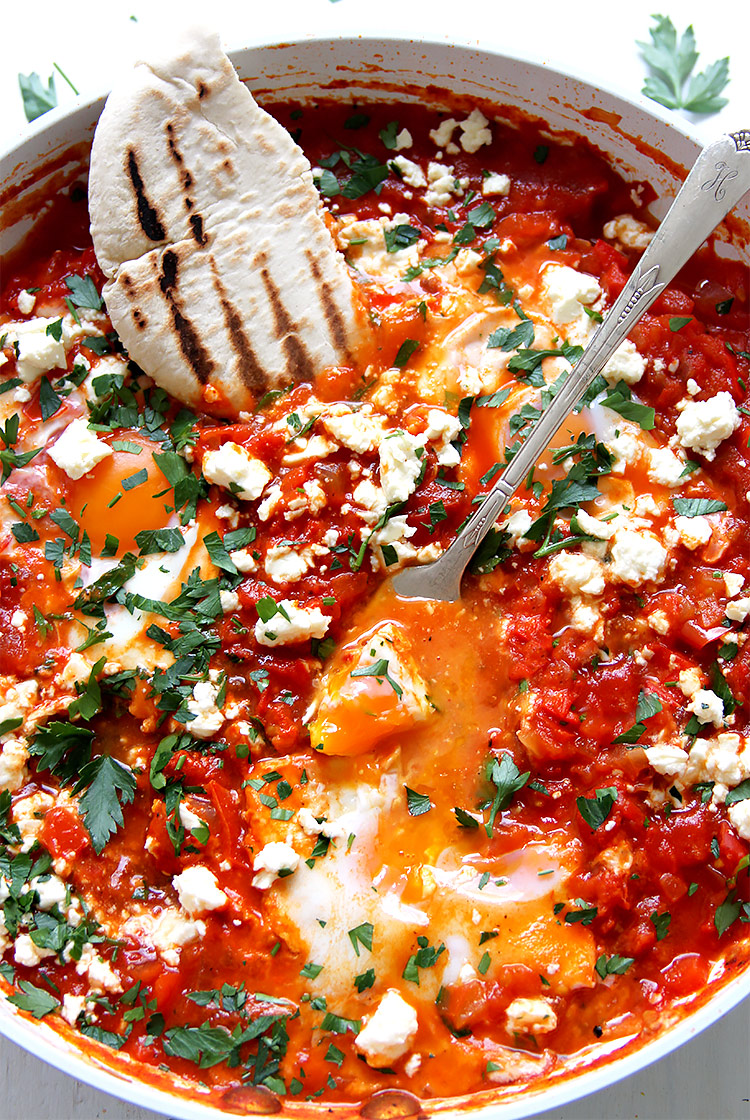 Shakshuka with pita bread in pan