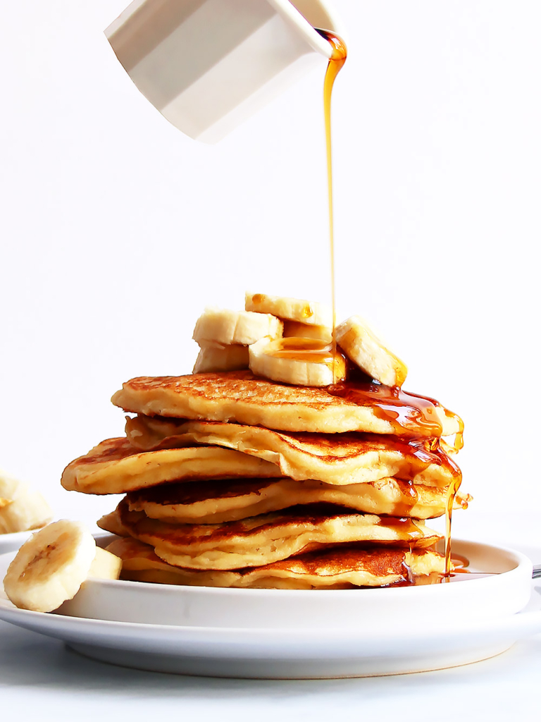 Stack of pancakes drizzled with syrup