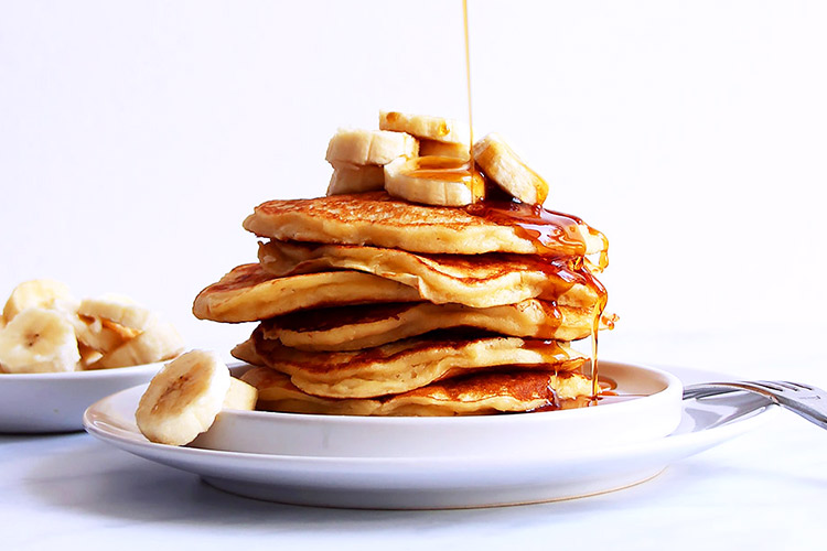 Stack of pancakes drizzled with syrup