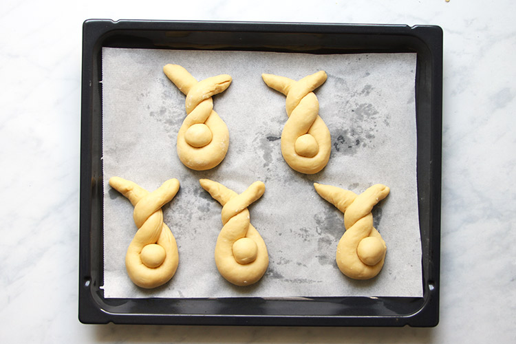 Shaped Easter bunnies on baking sheet