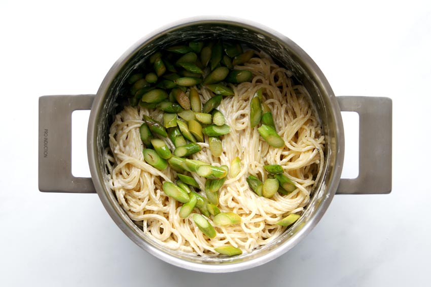 Pot with sauce, pasta, and asparagus