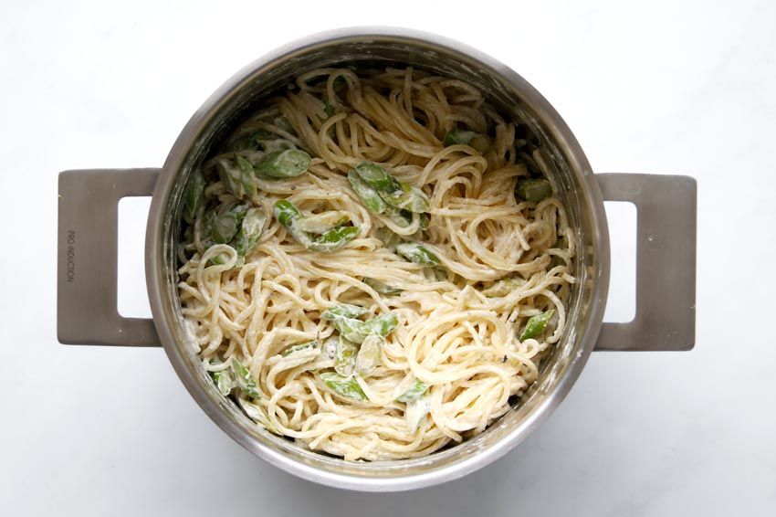 Pasta and asparagus tossed in sauce