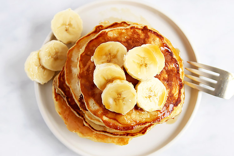 Pancakes topped with banana slices