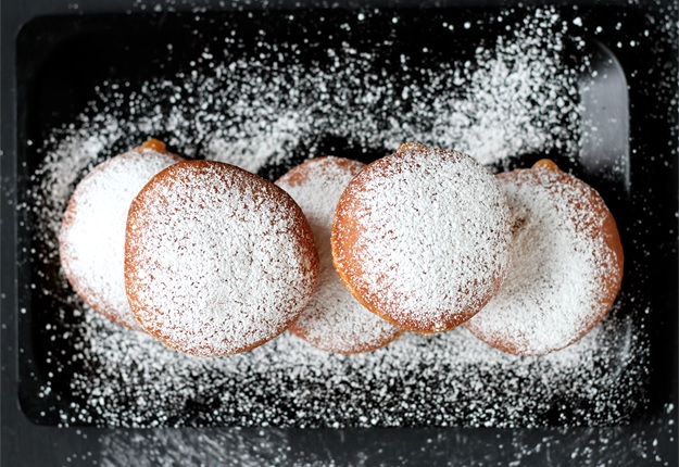 Krapfen dusted with confectioners' sugar