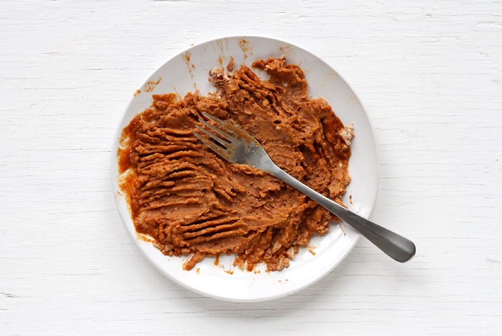 Mashing beans with fork